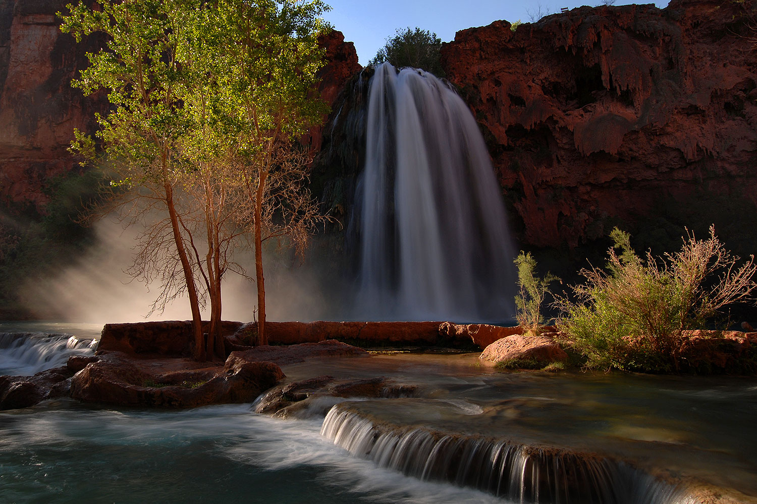 Morning sun rays shining at the mist of Havasu Falls - 120 ft drop (37 meters) â€¦ April 2008
