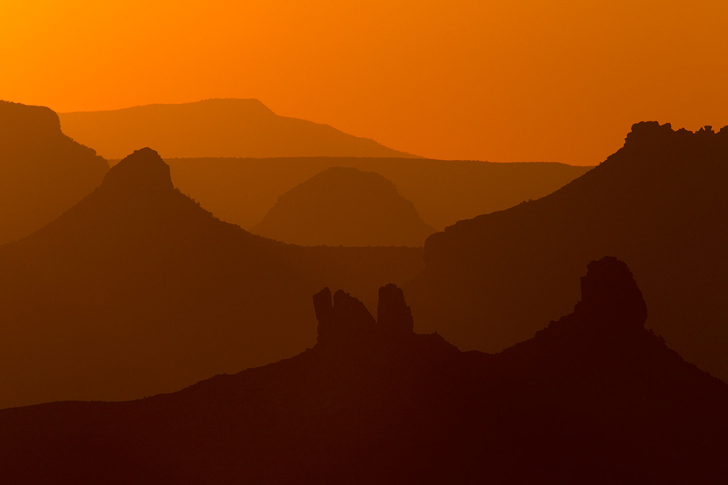 Mountain silhouettes at sunset in Grand Canyon â€¦ August 2010