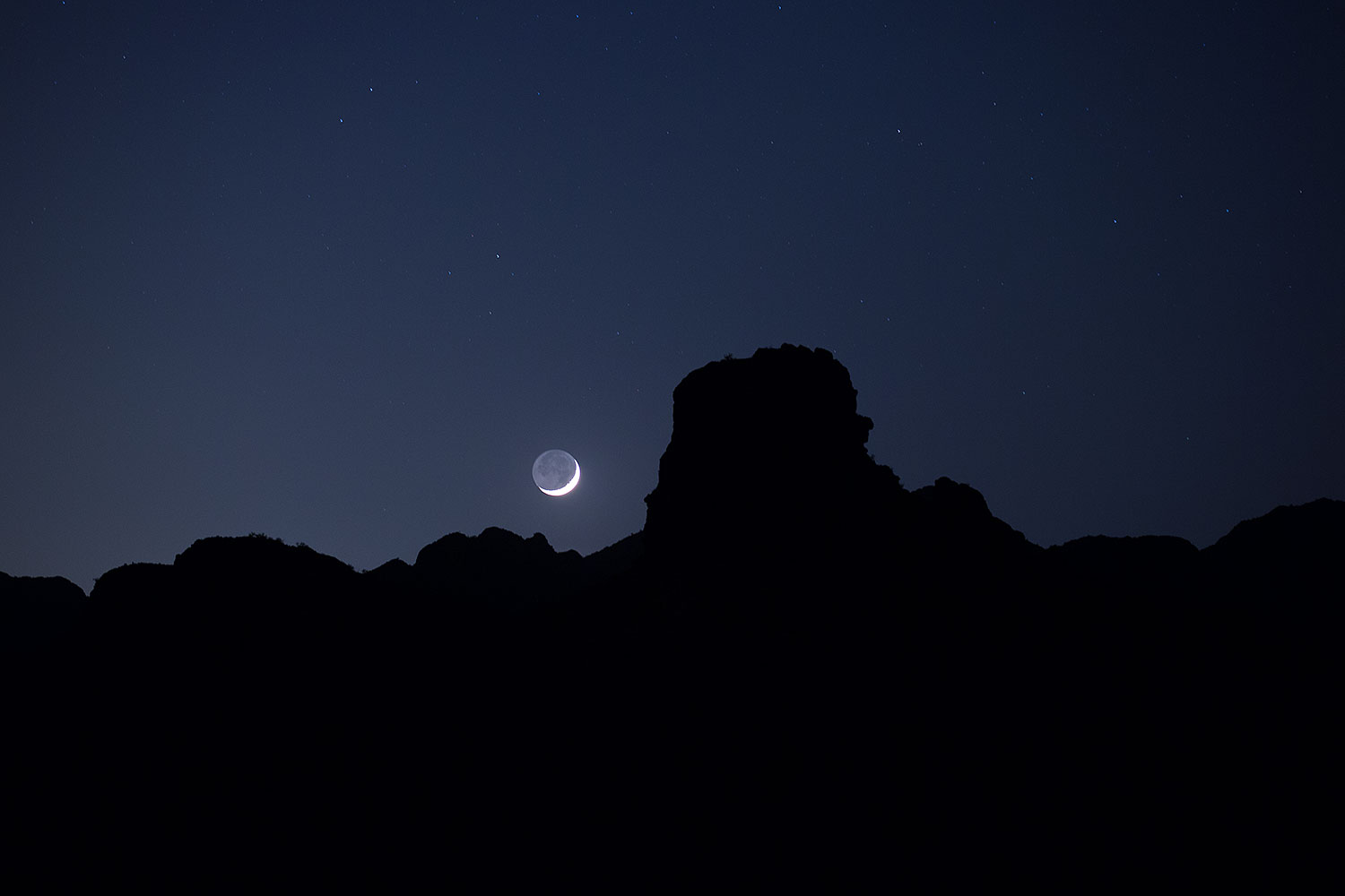 Mountain silhouettes and crescent moon in Superstitions â€¦ May 2013